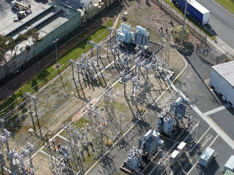 Ferntree Gully, Australia - 24 August 2026: Aerial view of Ferntree Gully Zone Substation with electrical transformers, switchgear, and metal structures in a fenced compound.