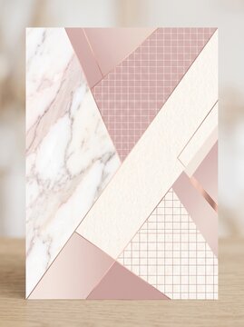 Abstract geometric background with rose gold marble and grid patterns on a wooden surface.
