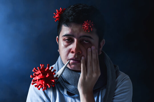 Sick young man and red virus cells on dark background