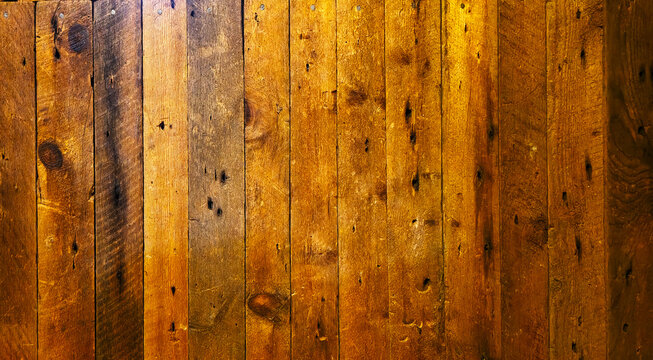 Rustic vertical brown wood plank wall background with rich natural grain and knots
