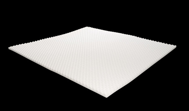 Close-up of white convoluted egg crate foam topper layer for mattress, bedding material isolated on black background