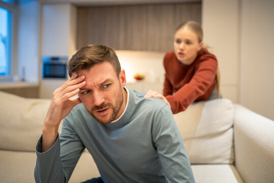 Thoughtful woman partner attempts to make peace with offended husband after family conflict, manipulative man refusing and ignoring wife, toxic uncertain partnership, resentment and immaturity.