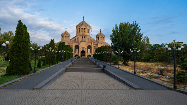 Saint Gregory the Illuminator Cathedral in Yerevan, Armenia, is seen from its wide approach walkway under a blue sky.