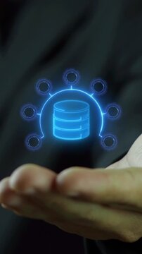 Businessman open hand vertical shot supporting glowing database storage disks with circular network node arc. Decentralized data infrastructure, centralized server hub, and connectivity concept.