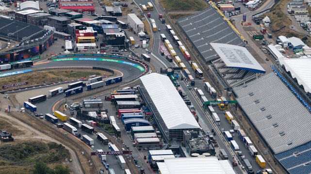 Zandvoort, Netherlands - 16 August 2026: Aerial view of MASCOT Circuit Zandvoort showing the paddock area filled with team trucks, trailers, and grandstands.