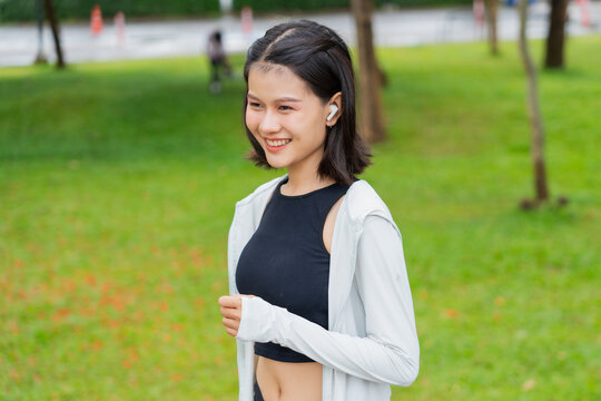 Asian sporty woman running in public park