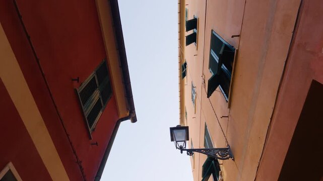 Camera moves from narrow alley upward to reveal colorful courtyard and houses