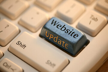 Obraz premium A close-up shot of a keyboard featuring a custom website update key with warm lighting. Ideal for internet maintenance and digital marketing themes.