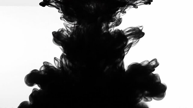 Abstract black ink swirling in white liquid with artistic smoke effect and fluid motion