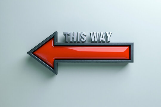 A shiny red metal arrow pointing left with the text this way stands against a clean background. It serves as a modern directional sign for navigation.