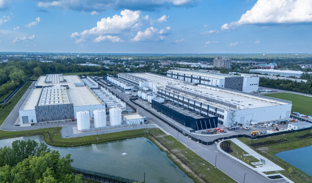 Hilliard, Ohio, United States - 21 August 2026: Aerial view of the Amazon data center with large industrial buildings, storage tanks, and green space under a blue sky.