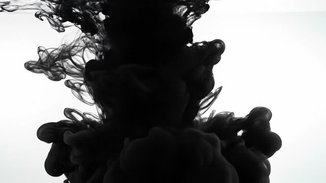 Abstract black ink swirling in water with white background artistic fluid motion