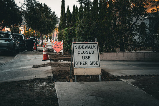 Sidewalk closed sign indicates detour for pedestrian traffic during construction