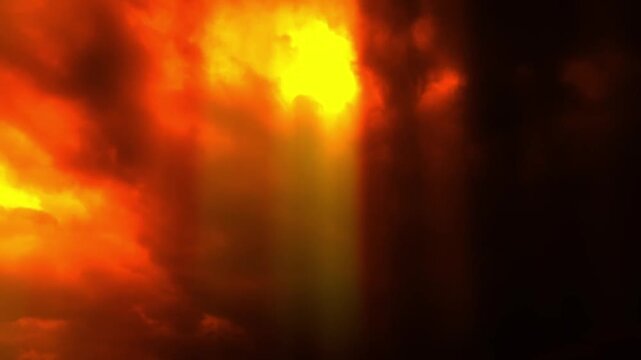 Dramatic fiery red and dark storm clouds moving across the sky with glowing light rays