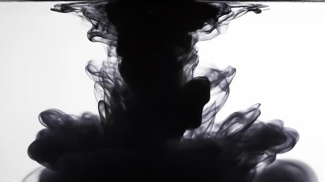 Black ink swirling in water with abstract fluid smoke effect on white background