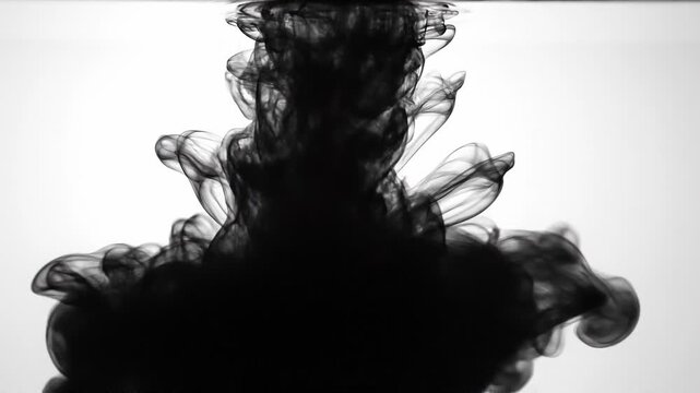 Abstract black ink swirling in water with smoky smoke effect on white background