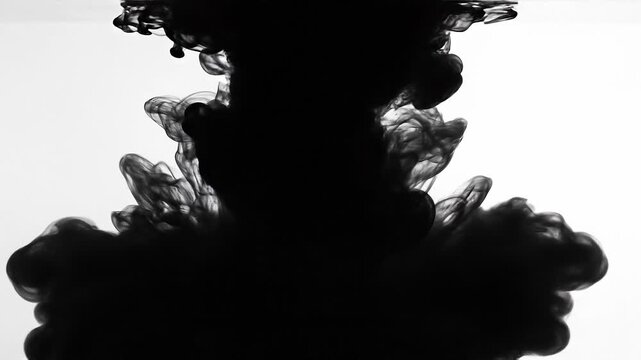 Abstract black ink swirling in water with smoke like patterns on white background