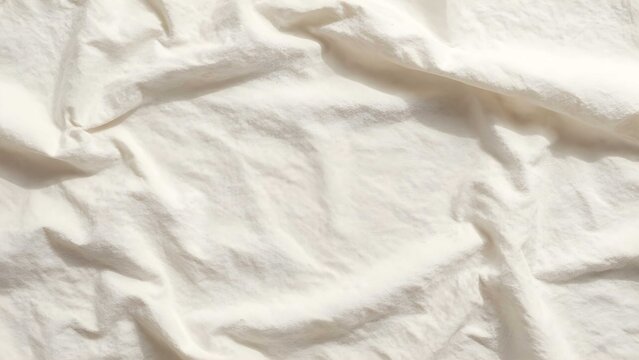 Neutral cotton backdrop featuring irregular creases and highlights