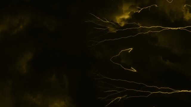 Dramatic dark storm clouds with intense lightning strikes and flashes in the night sky