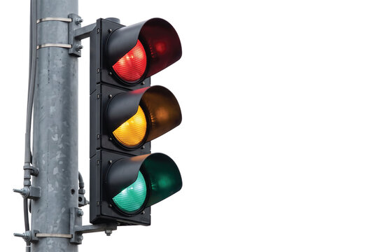 Traffic light with red yellow and green signals on a pole against sky