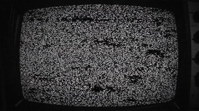 Abstract black and white image showing textured surface with reflective light patterns and noise effect