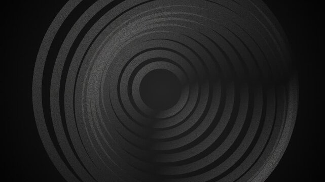 Abstract dark background featuring concentric circular ring patterns in black
