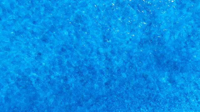 Top view of deep blue sea water surface with small ripples, aerial drone shot of turquoise ocean texture at island , abstract nature background	
