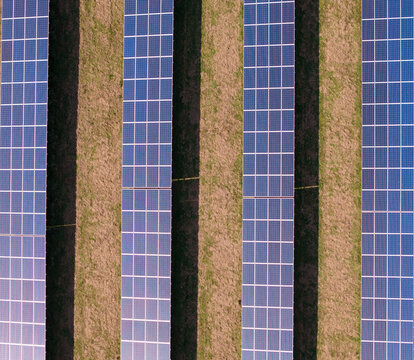 Aerial view of Lisburn Solar Farm featuring rows of photovoltaic panels arranged in neat lines across the green landscape Lisburn, Northern Ireland, United Kingdom.