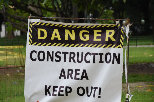 Danger sign. Construction Area, Keep Out sign on a white cloth hanging outdoors.
