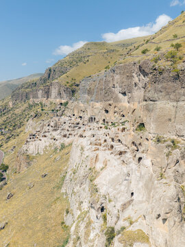 Aerial view of Vardzia cave monastery carved into the rocky cliffside with ancient dwellings and tunnels Gogasheni, Samtskhe-Javakheti, Georgia.
