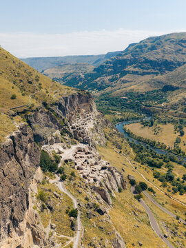 Aerial view of Vardzia cave monastery complex carved into the Erusheti Mountain, overlooking the Mtkvari River, with rocky cliffs in Gogasheni, Samtskhe-Javakheti, Georgia.