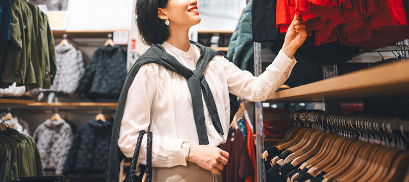 Happy asian woman shopping clothes in fashion shoping mall