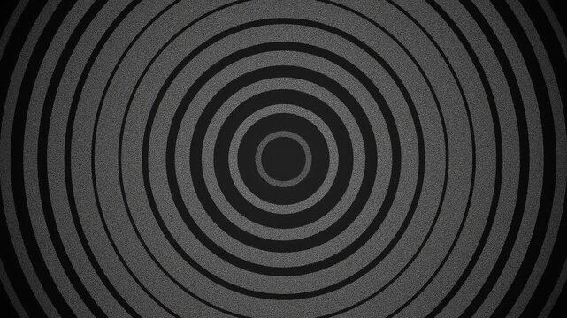 A symmetrical pattern of concentric dark gray and black circles in a design