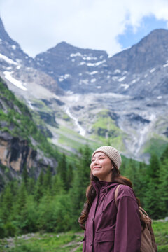 Vertical portrait image of a woman with mountain range in summertime, Chengdu, China