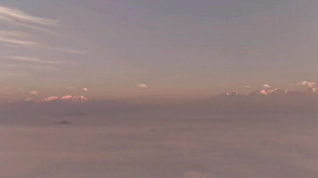 Snow capped Himalayan peaks above sea of clouds in Nepal