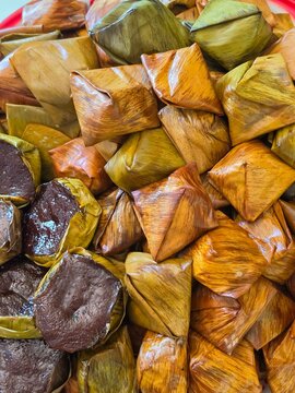 Thai dessert mixed with glutinous rice flour, green beans, salt and pepper wrapped in banana leaves and steamed (Khoaw nom tien)