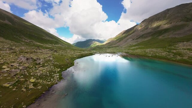 Aerial Forward Flight Over Turquoise Mountain Lake and Valley