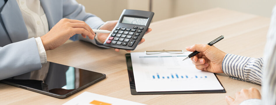 Business meeting, asian group brainstorm analysis on graph data of cost plan. financial consult planning investor asses and present to client, client and advisor review investment strategy in office.