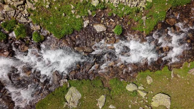 Fast flowing mountain stream over rocks from above