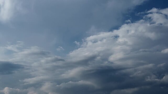 Timelapse of clouds moving across blue sky