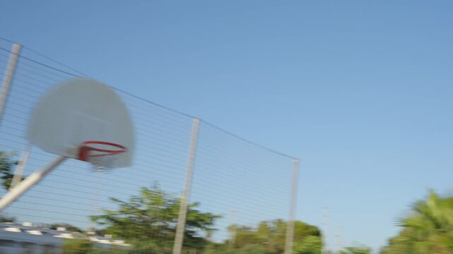 Urban basketball player scoring on a seaside court