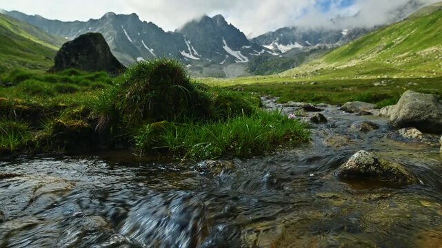 Stream flowing through an alpine mountain valley