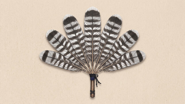 Traditional native style feather fan made of striped turkey feathers on beige background