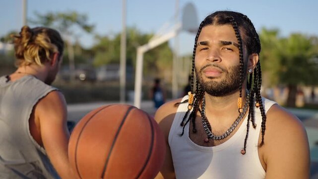 Talented basketball player spinning a ball on finger outdoors