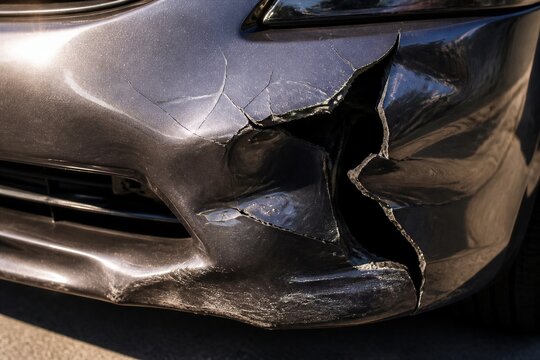 Car front bumper dented and cracked after collision
