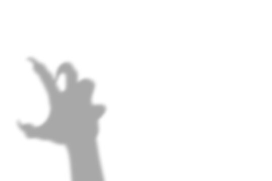 A dark scary hand silhouette cast by a mysterious person reaching out in the shadows presented as an isolated object isolated on transparent background