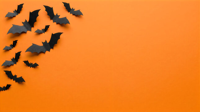 Black bat silhouettes flying against orange background illustration
