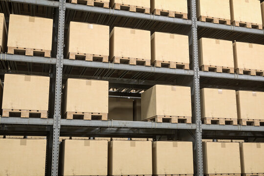 Warehouse racking full of cartons with one empty shelf level