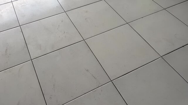 Clean tiled floor surface with diagonal grid pattern lines