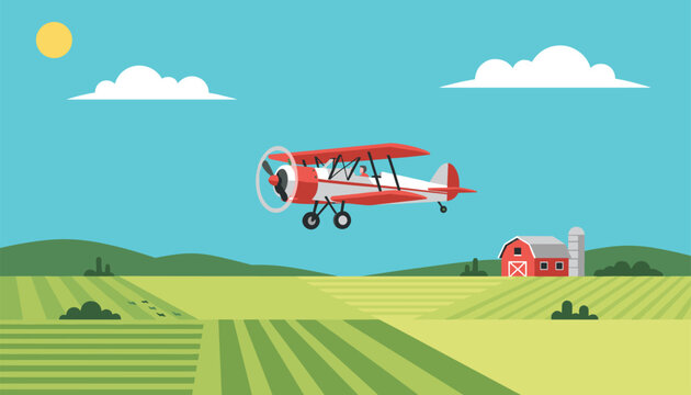 Vintage red and white biplane flying high over vast green agricultural crop fields with a red barn and silo below.